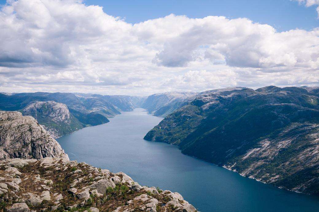 A mountain view of other mountains and a great moving body of water